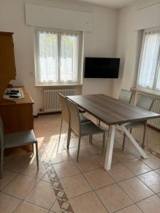 a dining room with a wooden table and chairs at Villa Ginestra in Molveno
