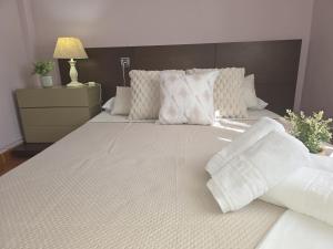 a bedroom with a large bed with white sheets and pillows at La Casa de Lidya - 36801 in Entrambasaguas +8 photos