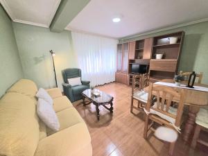 a living room with a couch and a dining room at La Casa de Lidya - 36801 in Entrambasaguas