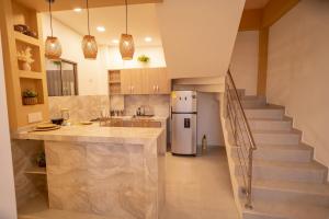 a kitchen with a staircase and a white refrigerator at Casa Chongui in Lorica