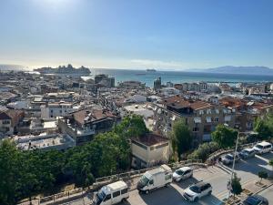 a city with cars parked in a parking lot at Hbs Hotel in Kuşadası