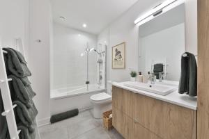 a bathroom with a sink and a toilet and a shower at Verbier by Tremblant Platinum in Mont-Tremblant +27 photos