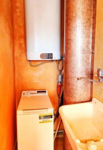 a white refrigerator in a room with a sink at Appartamento il Lentischio a 5 minuti dal mare a Cardedu in Cardedu +13 photos
