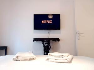 A television and/or entertainment centre at Green tea balcony - quiet & cozy- Ano Glyfada