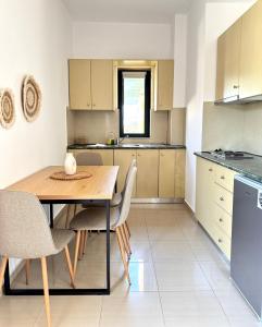 a kitchen with a wooden table and chairs at Pachia Ammos Falasarna in Falasarna