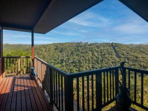 a balcony with a view of a forest at CK House in Wilderness +8 photos