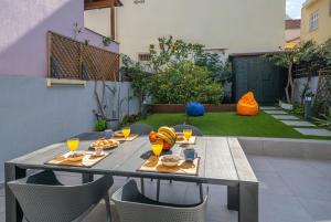 a table with food and drinks on a patio at Argostoli Haven - Luxury House in Argostoli