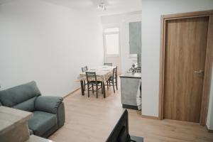 a living room with a couch and a kitchen with a table at Casa vacanza Ro-Bè in Rocca San Giovanni