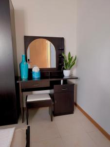 a bathroom with a desk with a mirror at Sunset Haven Manikata - Walking distance to Golden Bay in Manikata