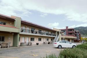 a white car parked in front of a building at Waterfront Inn in Penticton
