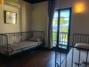 una camera da letto con un letto e una grande finestra di Villa Posidi with Private Pool and Sea View a Possidi Altre 10 foto