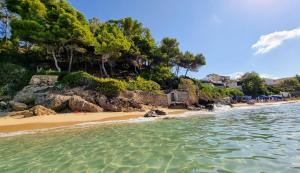 a beach with clear water and a rocky shore at Argostoli Haven - Luxury House in Argostoli