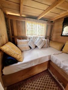 a large couch in the inside of a room with pillows at Tente-Cabane en Quercy in Planioles