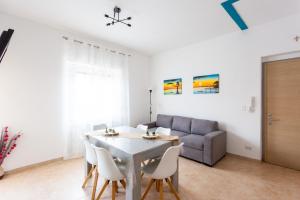 a living room with a table and a couch at Casa Rachele in Porto San Giorgio +25 photos