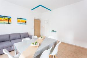 a living room with a couch and a table and chairs at Casa Rachele in Porto San Giorgio