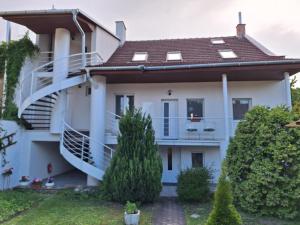 a house with a balcony and stairs at Star Apartments in Piešťany