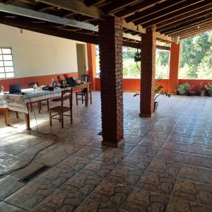 a large room with a table and chairs in it at Pousada Vida Nova Taguá Ouro Fino in Ouro Fino