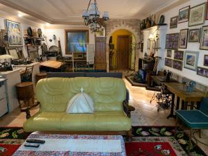 a living room with a green couch and a table at DB Apartment in Tirana