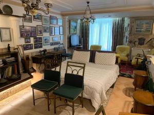 a living room with a bed and chairs at DB Apartment in Tirana
