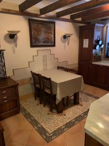 a kitchen with a table and chairs in a room at DB Apartment in Tirana