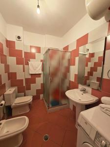 a bathroom with a shower and a toilet and a sink at Sion Sarande Apartments in Sarandë