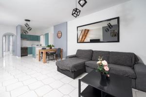 a living room with a couch and a table at Thalori Akra escape in Paralía Akrátas