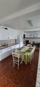 a kitchen with a table and chairs in a room at Casa Santos in Angra do Heroísmo