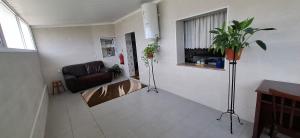 a living room with a couch and a window at Casa Santos in Angra do Heroísmo