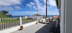 a balcony with a white fence and a view of the ocean at Casa Santos in Angra do Heroísmo