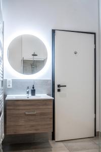 a bathroom with a sink and a mirror at Oran Apartment 7 in Berlin