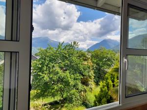 a window with a view of the mountains at Chez Welter in Argelès-Gazost +2 photos