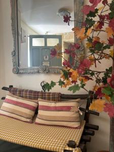 a mirror above a bed with pillows in a room at Cueva Colorin Alloza. in Alloza