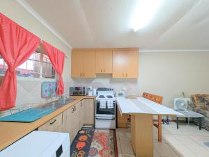 a kitchen with a sink and a stove top oven at Windhoek King Room Near City Centre, Windhoek in Windhoek