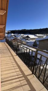 a wooden walkway next to a body of water at Appartement 4 personnes in Les Fourgs