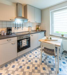 a kitchen with a table and a stove at Wohlfühl-Appartement in Brilon in Brilon