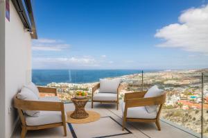 a balcony with chairs and a view of a city at Presidential Suite 350m2 Bellavista on one level,Private SPA&HEATED POOL in Adeje