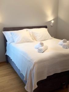 a bed with towels on top of it at Sadama Apartment in Haapsalu