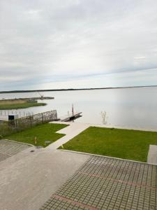 a view of a body of water with a bench at Sadama Apartment in Haapsalu +1 photo