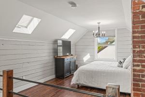 a bedroom with a bed and a television in a room at Stunning Heritage Home, Sleep 10, Hot Tub, Private Yard, Firepit, in Vernon +82 photos