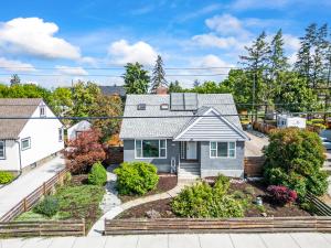 an image of a house with a garden at Stunning Heritage Home, Sleep 10, Hot Tub, Private Yard, Firepit, in Vernon