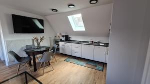 a kitchen and dining room with a table and chairs at Ferienwohnung Bettmatten in Ettenheim