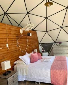 a bedroom with a bed with a wooden wall at Eco Boutique-Naranjo in La Vega +29 photos