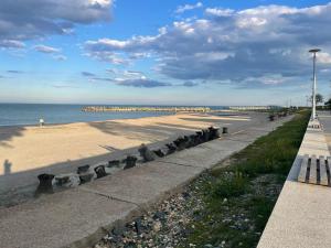 a beach with a row of cement barriers next to the ocean at LaNoi LaVoi in Mangalia