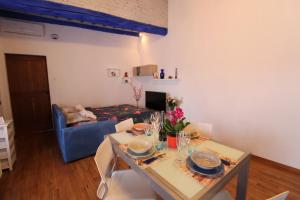 a living room with a table and a blue couch at La Casina - Tipica casa toscana Accoglienza e Relax in Colle Val D'Elsa