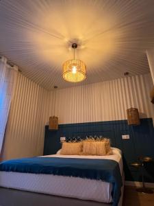 a bedroom with a bed and a chandelier at Casal de pelaio in Barreiros