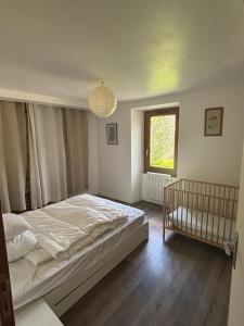 Postel nebo postele na pokoji v ubytování La Maison du Ruisseau