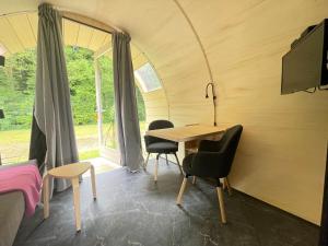 a room with a table and chairs in a tent at Eco-lodge, slow living by nature in Krim