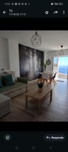 a living room with a couch and a table at La Lunita in Valverde