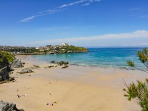 a group of people on a beach near the ocean at 49 Atlantic Reach in Newquay