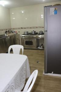 A kitchen or kitchenette at Wasi Airport Apartment